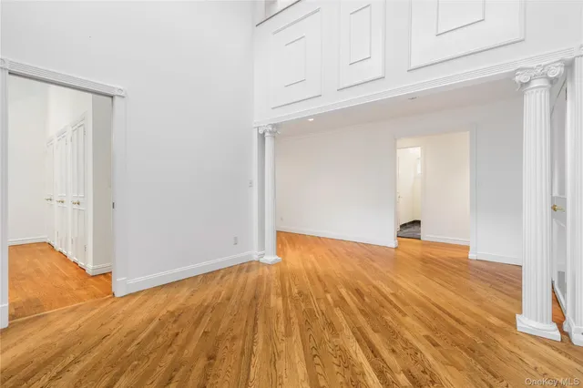a view of empty room with wooden floor