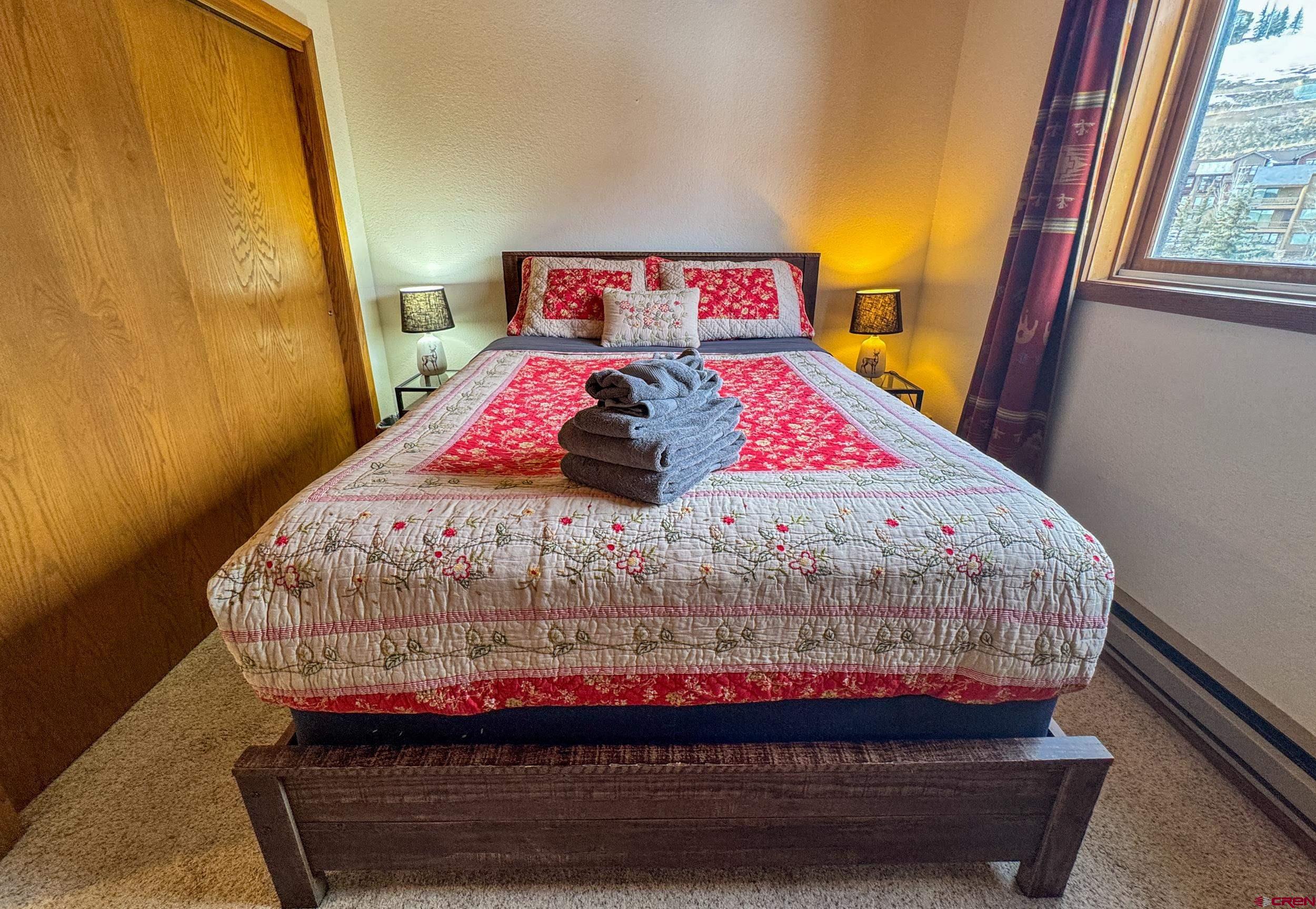 400 Gothic Road, Unit 305 Crested Butte, CO 81225 - Photo 19 of 38 a bedroom with a bed and wooden floor