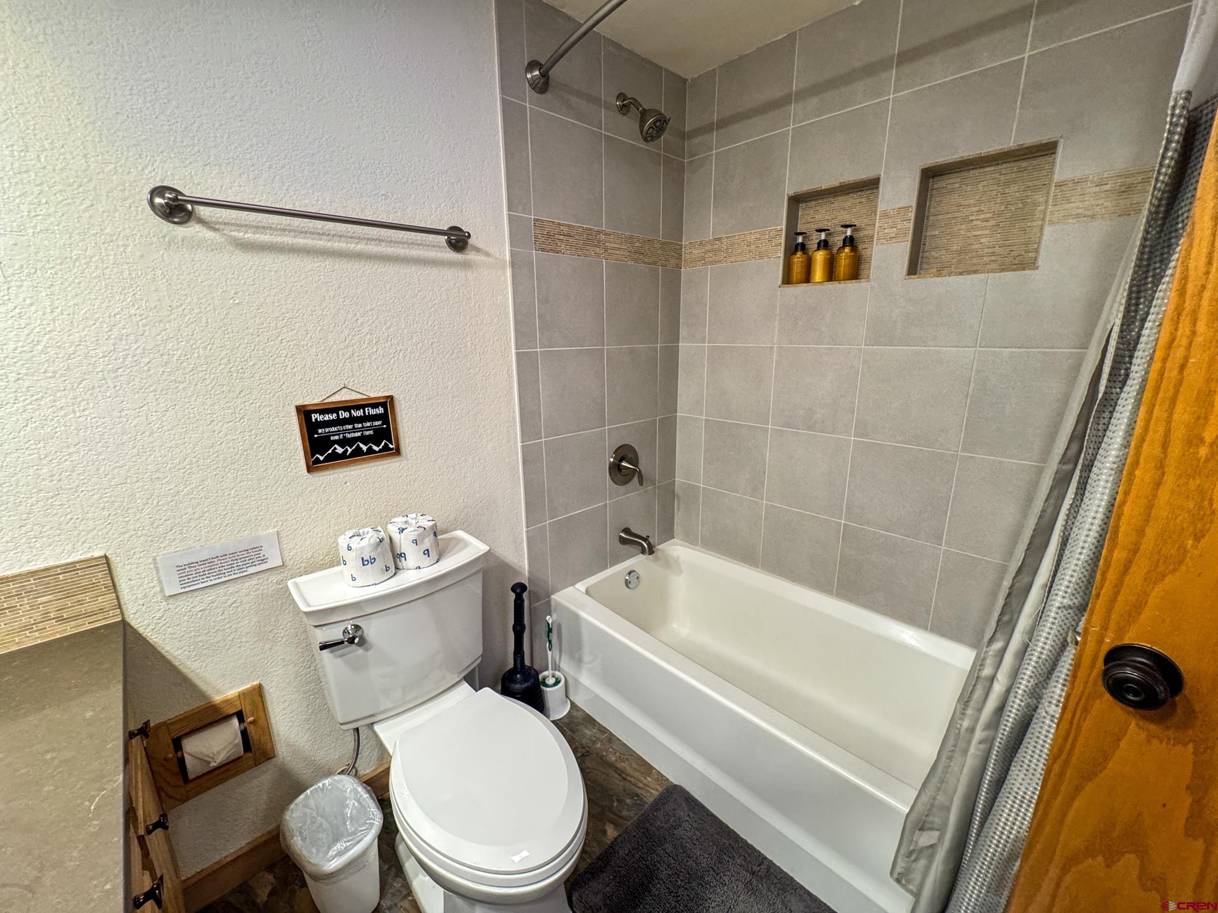 400 Gothic Road, Unit 305 Crested Butte, CO 81225 - Photo 21 of 38 a white toilet and tub sitting next to a bathroom sink