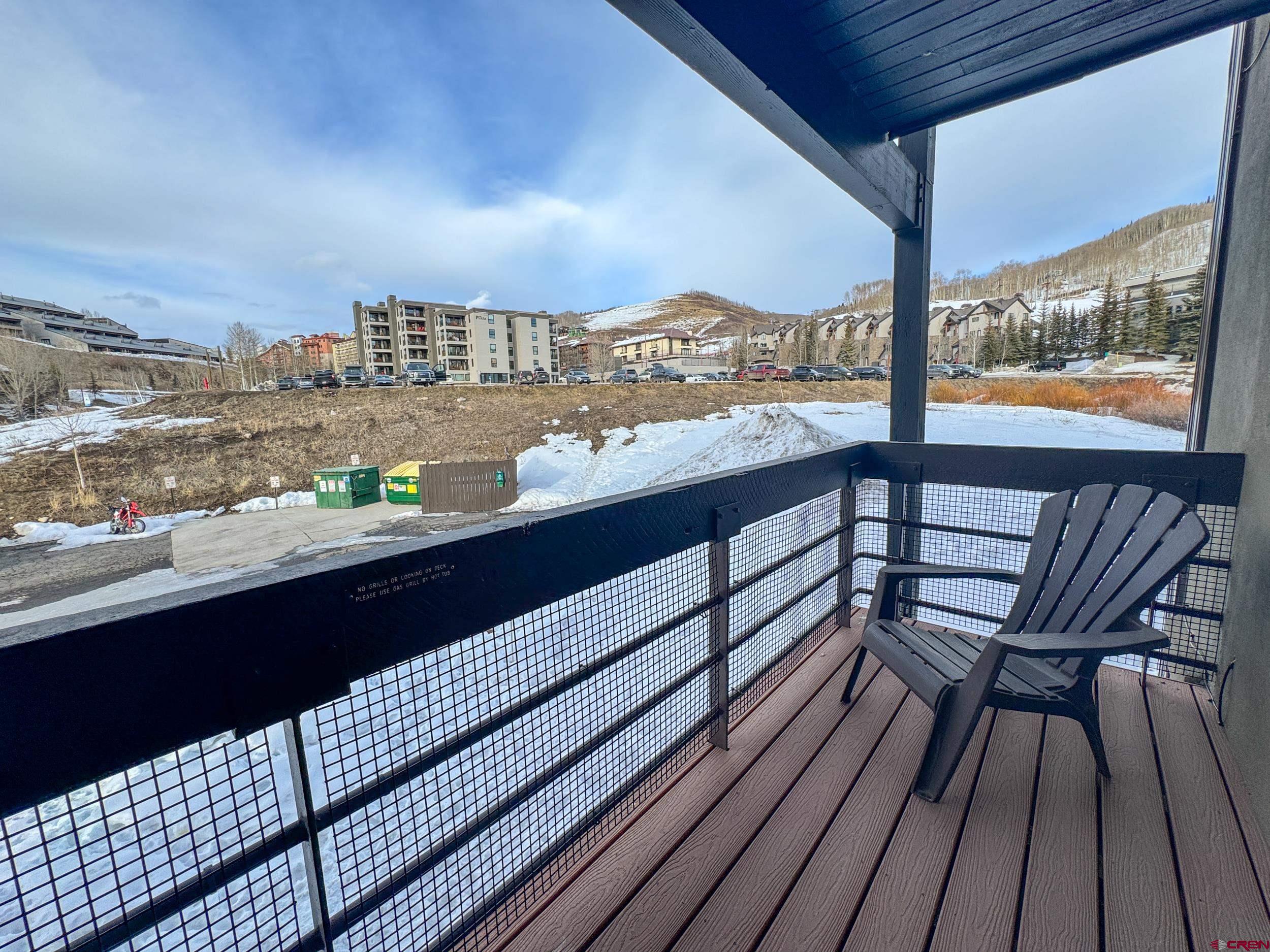 400 Gothic Road, Unit 305 Crested Butte, CO 81225 - Photo 23 of 38 a view of a balcony with wooden benches