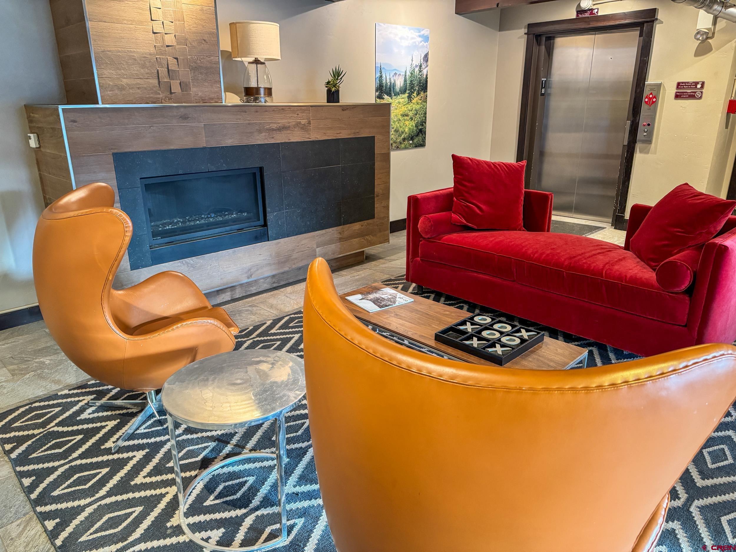 400 Gothic Road, Unit 305 Crested Butte, CO 81225 - Photo 35 of 38 a living room with furniture and a fireplace
