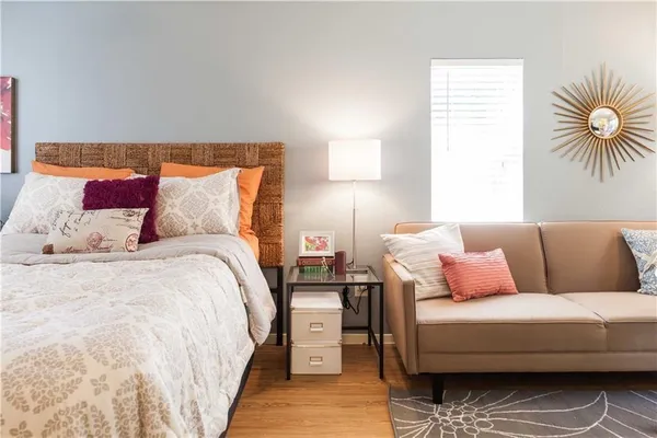 a bedroom with a bed and a couch