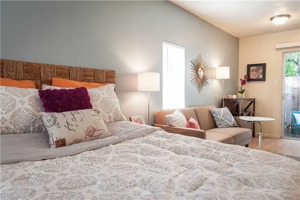 a bedroom with a large bed and a couch