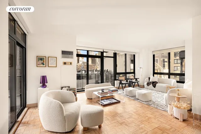 a living room with furniture and large windows