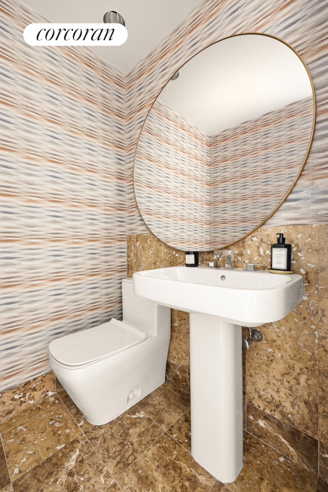 100 United Nations Plaza, Unit 7G Manhattan, NY 10017 - Photo 11 of 12 a bathroom with a sink and mirror