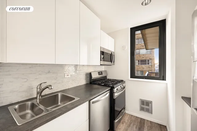 a living room with furniture a rug floor and a large window