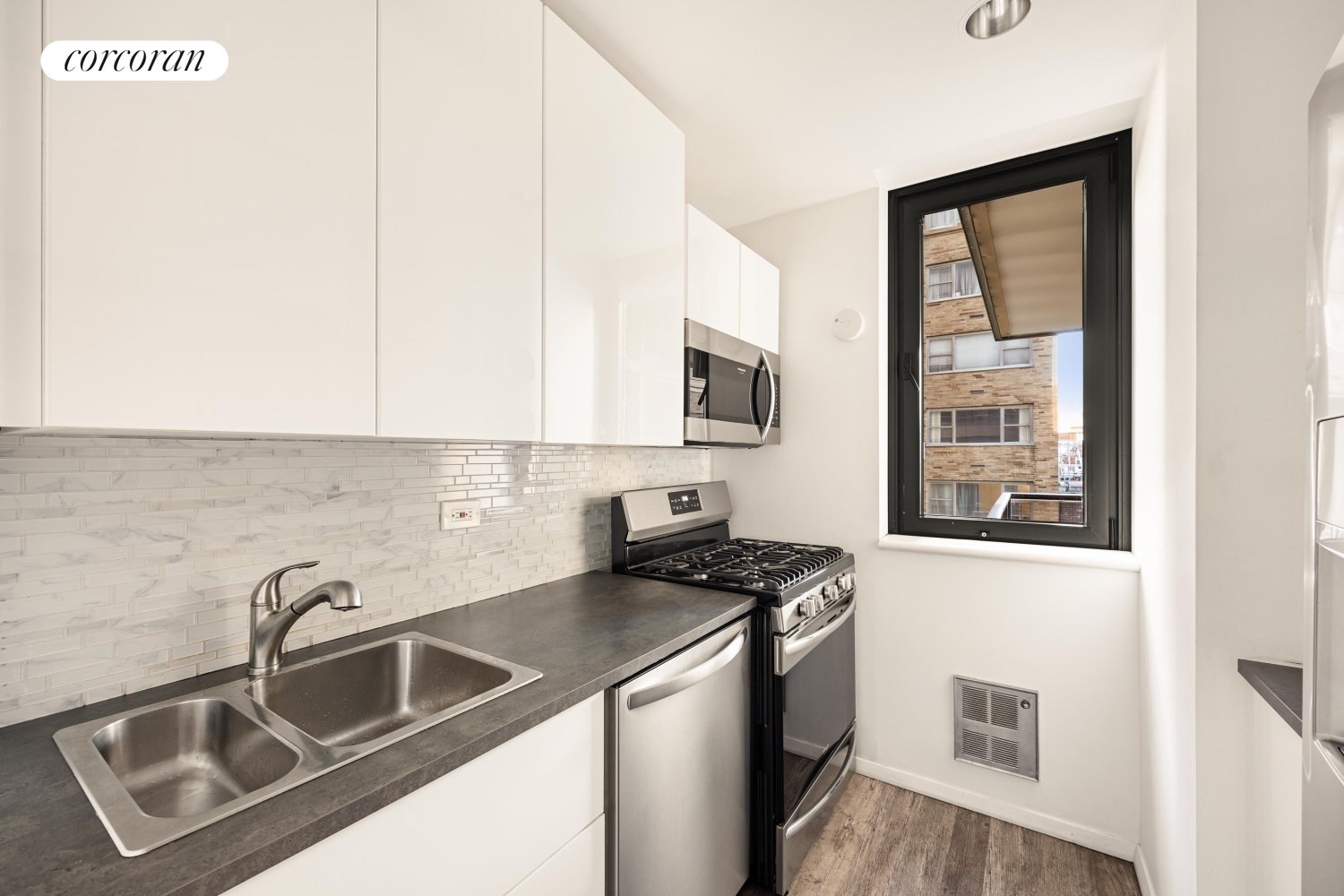 100 United Nations Plaza, Unit 7G Manhattan, NY 10017 - Photo 4 of 12 a kitchen that has a sink and a stove