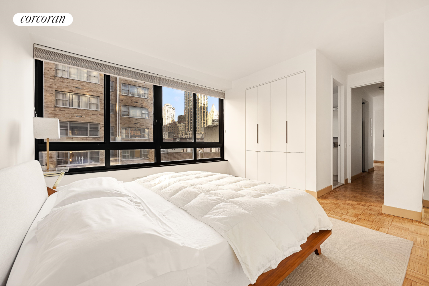 100 United Nations Plaza, Unit 7G Manhattan, NY 10017 - Photo 5 of 12 a spacious bedroom with a large bed and a large window