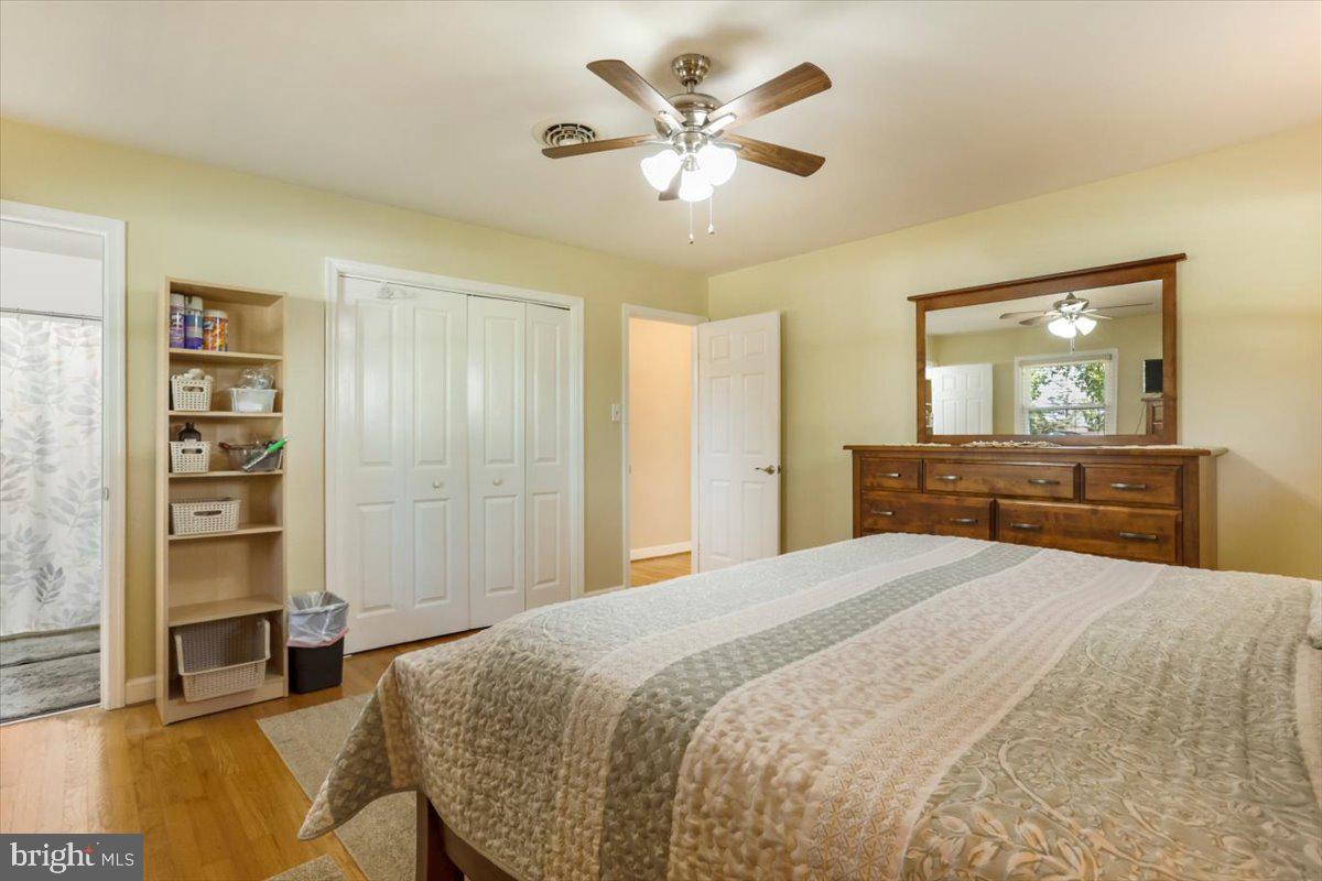 16040 Cloverton Lane Williamsport, MD 21795 - Photo 13 of 35 a spacious bedroom with a bed and a chandelier