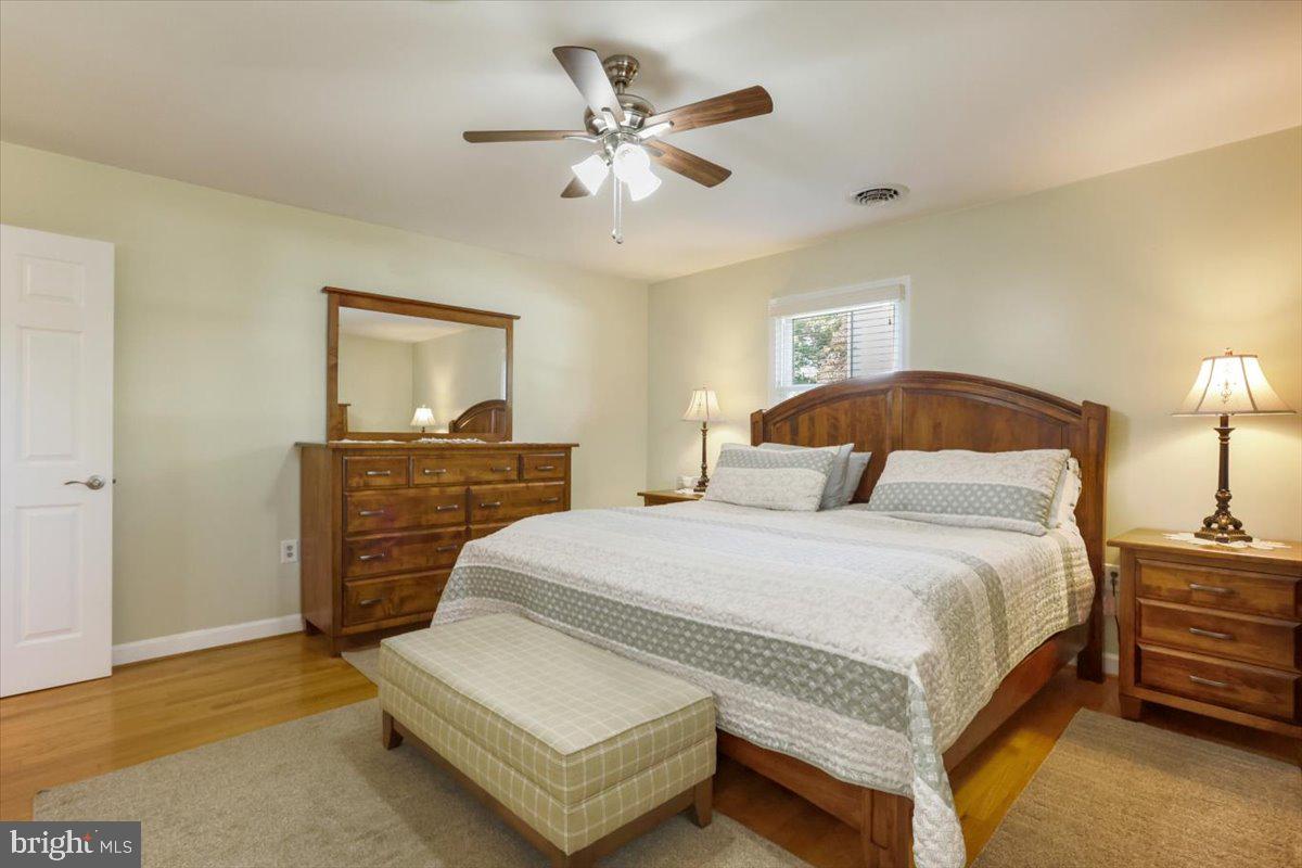 16040 Cloverton Lane Williamsport, MD 21795 - Photo 14 of 35 a bedroom with a bed and a chandelier