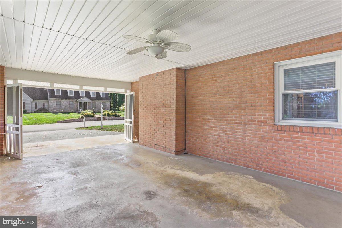 16040 Cloverton Lane Williamsport, MD 21795 - Photo 29 of 35 a view of a porch with a table and chairs under an umbrella