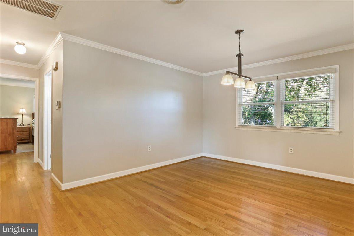 16040 Cloverton Lane Williamsport, MD 21795 - Photo 8 of 35 a view of an empty room with wooden floor fridge and a chandelier