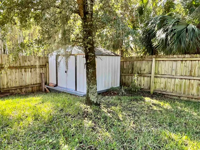 a view of a backyard with a tree