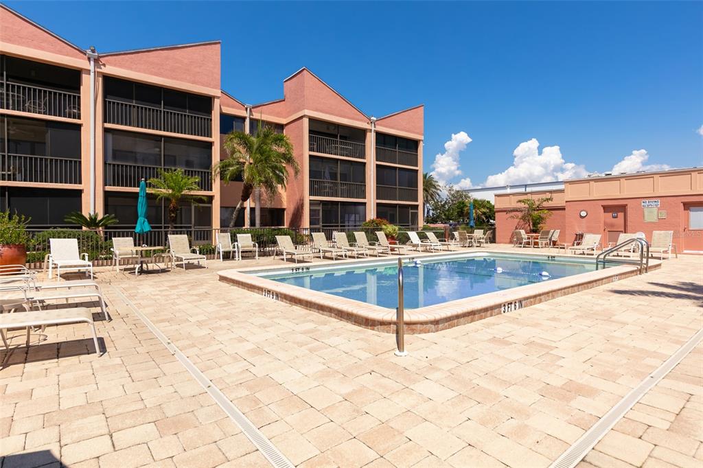 3160 Matecumbe Key Road, Unit 233 Punta Gorda, FL 33955 - Photo 21 of 33 a view of a building with a swimming pool and sitting area