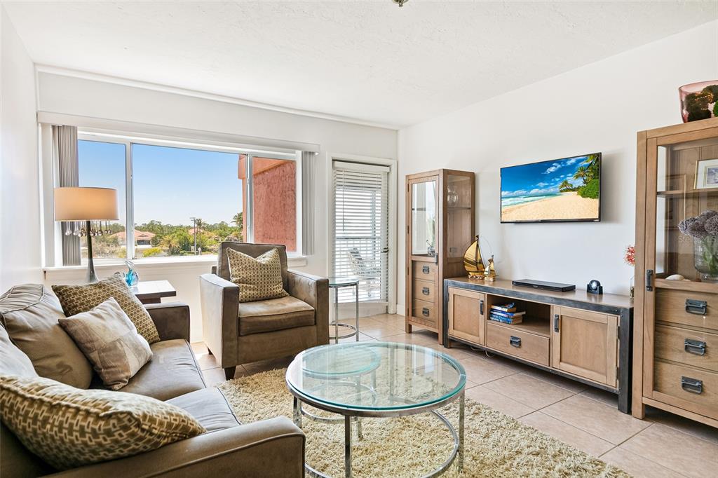 3160 Matecumbe Key Road, Unit 233 Punta Gorda, FL 33955 - Photo 6 of 33 a living room with furniture and a flat screen tv
