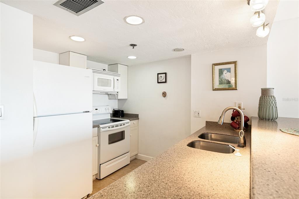 3160 Matecumbe Key Road, Unit 233 Punta Gorda, FL 33955 - Photo 10 of 33 a kitchen that has a sink and a stove