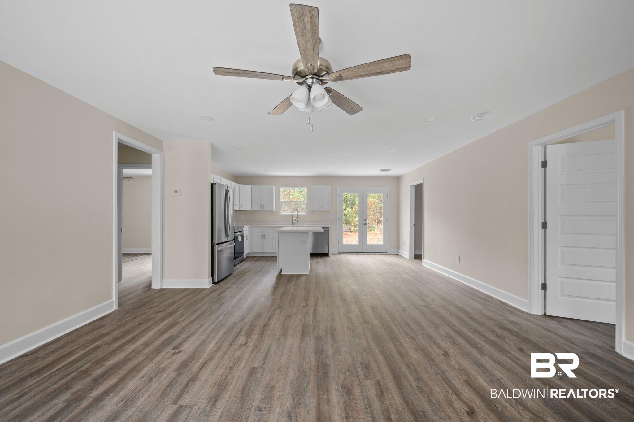 1473 Pollard Road Daphne, AL 36526 - Photo 6 of 32 Unfurnished living room featuring french doors, ceiling fan, dark hardwood / wood-style flooring, and sink