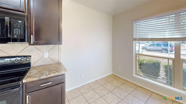 a view of kitchen with granite countertop window