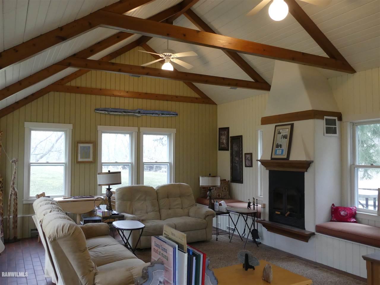 2692 North AYP Road Freeport, IL 61032 - Photo 24 of 67 a living room with furniture a fireplace and a chandelier
