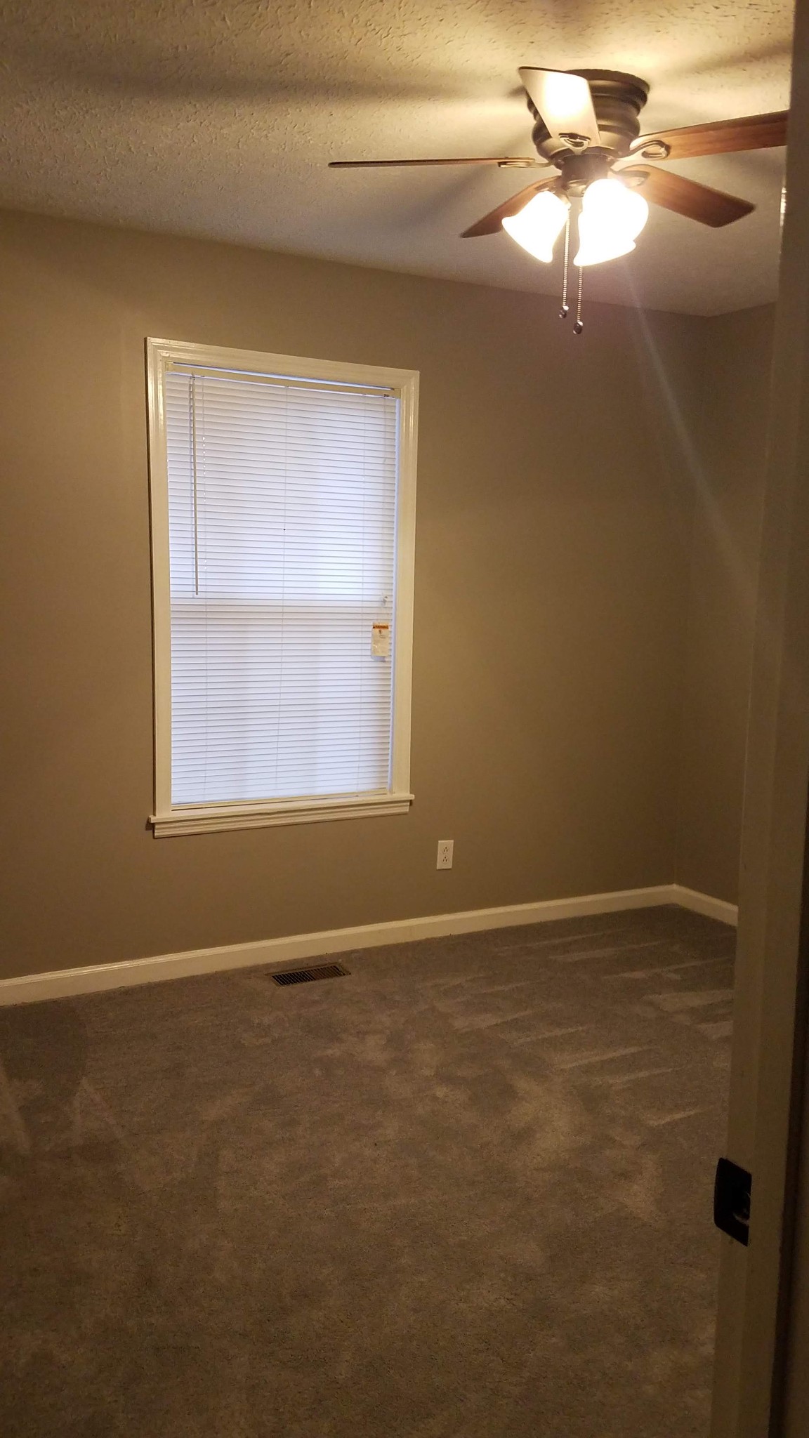 3784 Dot Road Springfield, TN 37172 - Photo 5 of 8 a view of an empty room with window and chandelier fan