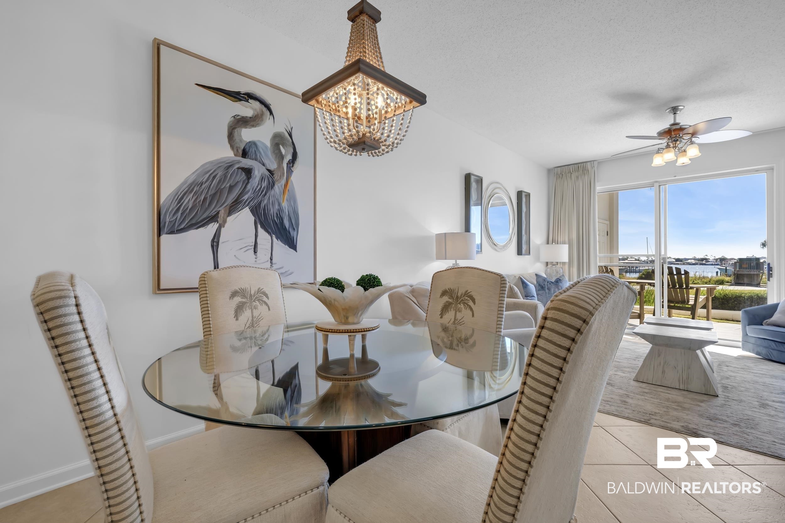 27282 Canal Road, Unit 104 Orange Beach, AL 36561 - Photo 28 of 79 Dining room featuring light tile patterned flooring, a chandelier, and a ceiling fan