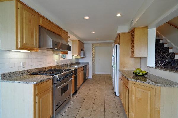 15 Parker Road Arlington, MA 02474 - Photo 13 of 19 a kitchen with stainless steel appliances granite countertop a stove a sink and a refrigerator