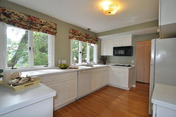 15 Parker Road Arlington, MA 02474 - Photo 6 of 19 a large white kitchen with a large window appliances and cabinets