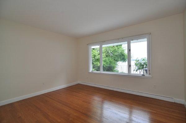 15 Parker Road Arlington, MA 02474 - Photo 10 of 19 an empty room with wooden floor and windows