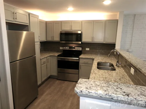 a kitchen with a refrigerator sink and microwave