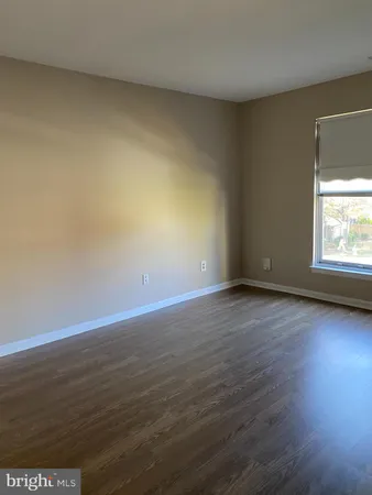 a view of an empty room and wooden floor