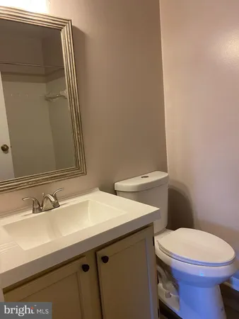 a bathroom with a sink a toilet and mirror
