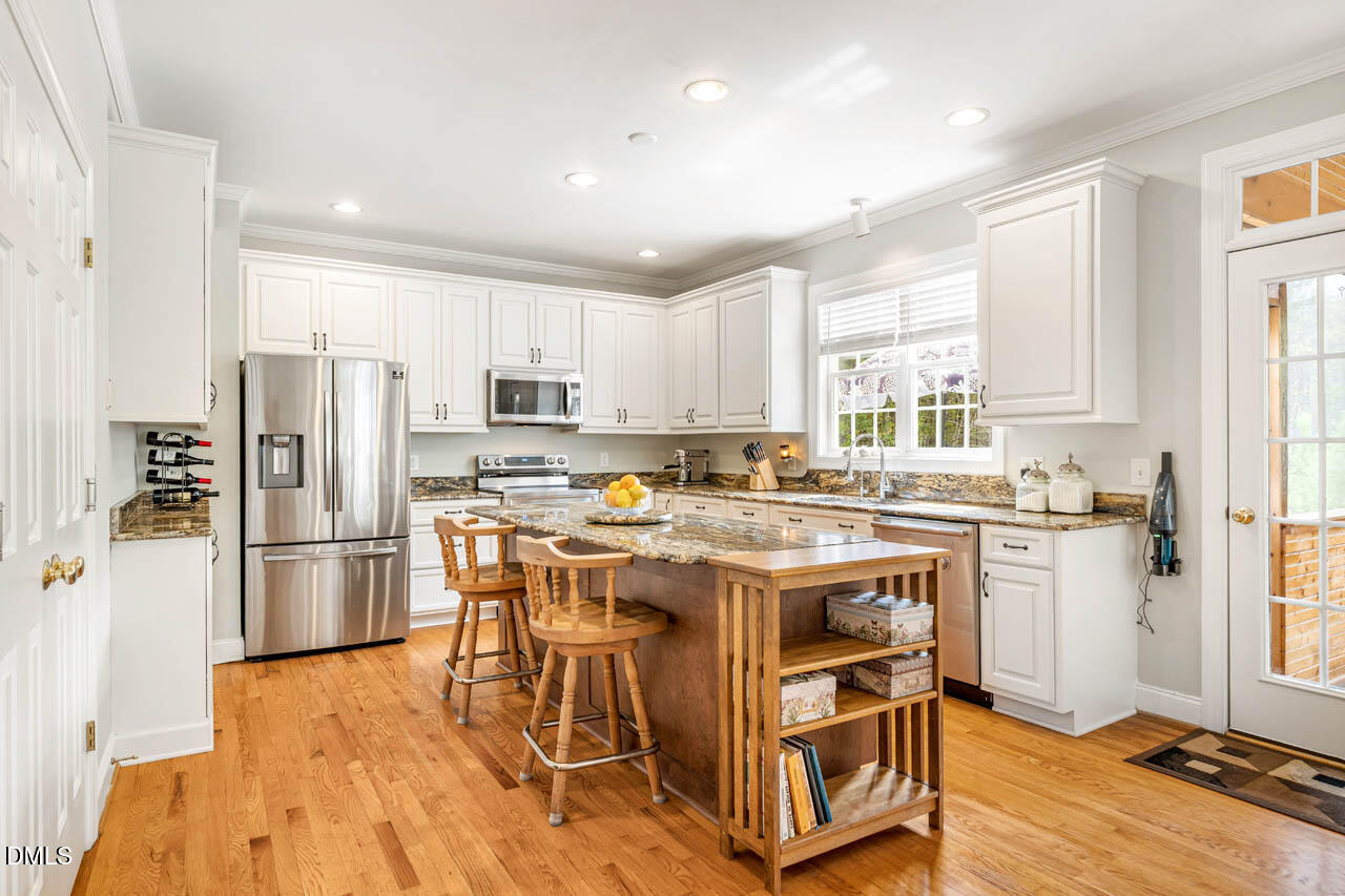 265 Old Chestnut Crossing Moncure, NC 27559 - Photo 13 of 45 a kitchen with a stove a refrigerator and a refrigerator
