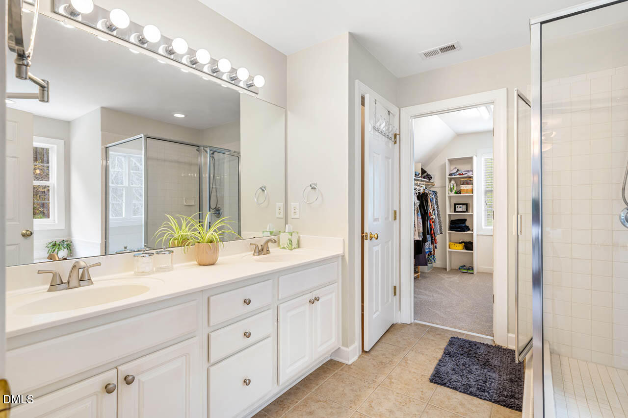 265 Old Chestnut Crossing Moncure, NC 27559 - Photo 21 of 45 a spacious bathroom with a double vanity sink a mirror and a shower