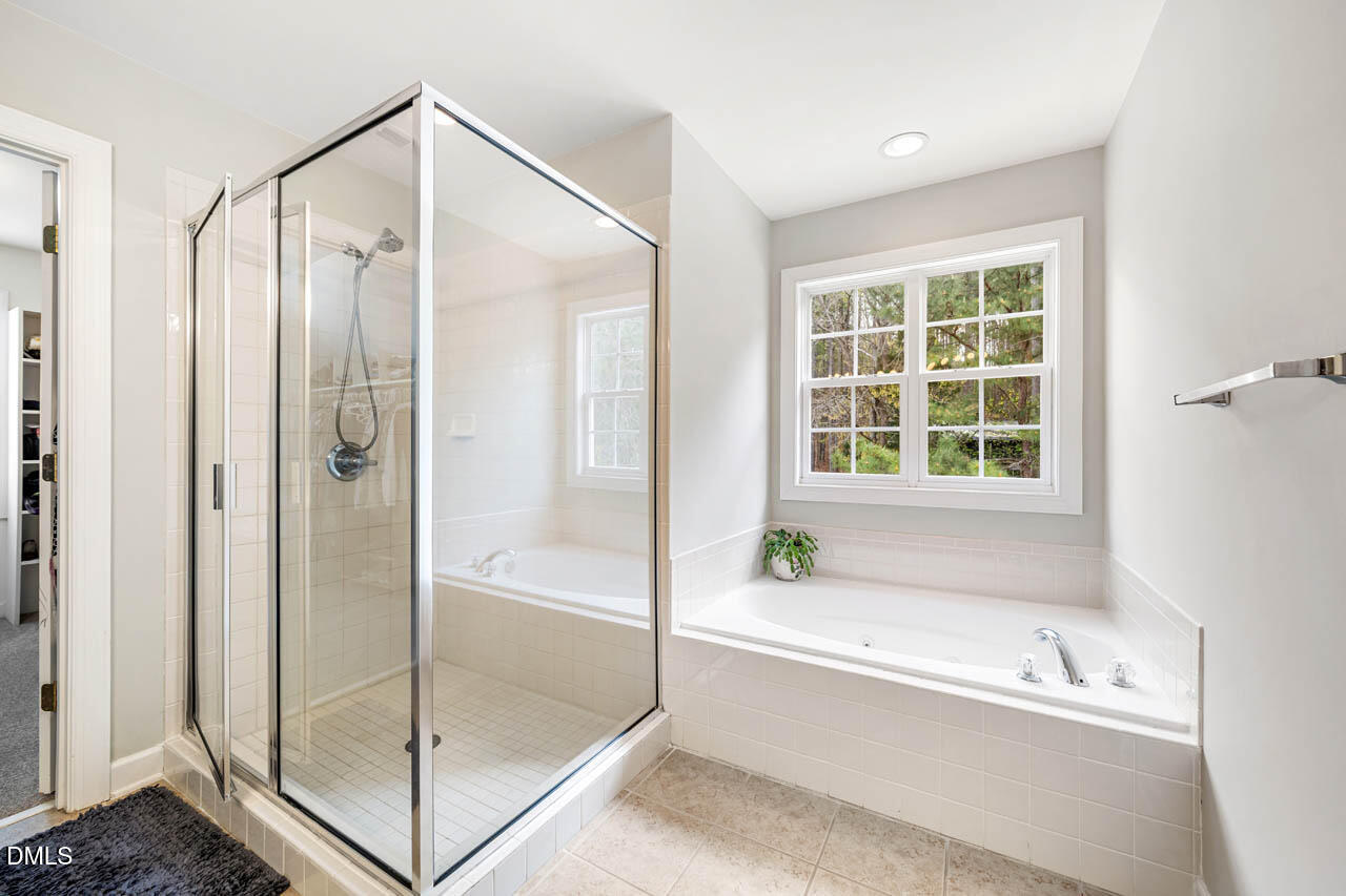 265 Old Chestnut Crossing Moncure, NC 27559 - Photo 22 of 45 a bathroom with a bathtub and a shower
