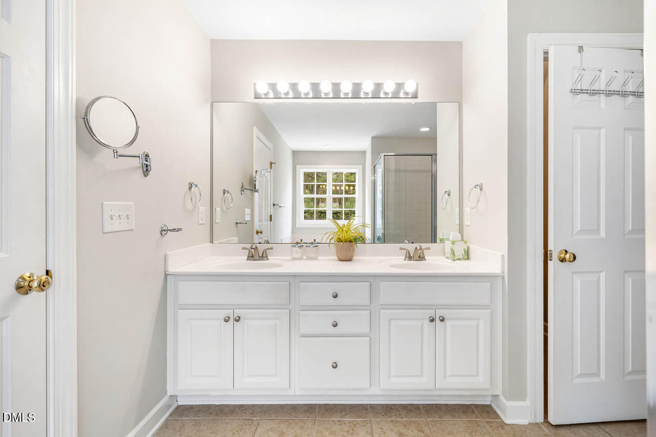 265 Old Chestnut Crossing Moncure, NC 27559 - Photo 23 of 45 a bathroom with a double vanity sink and a mirror