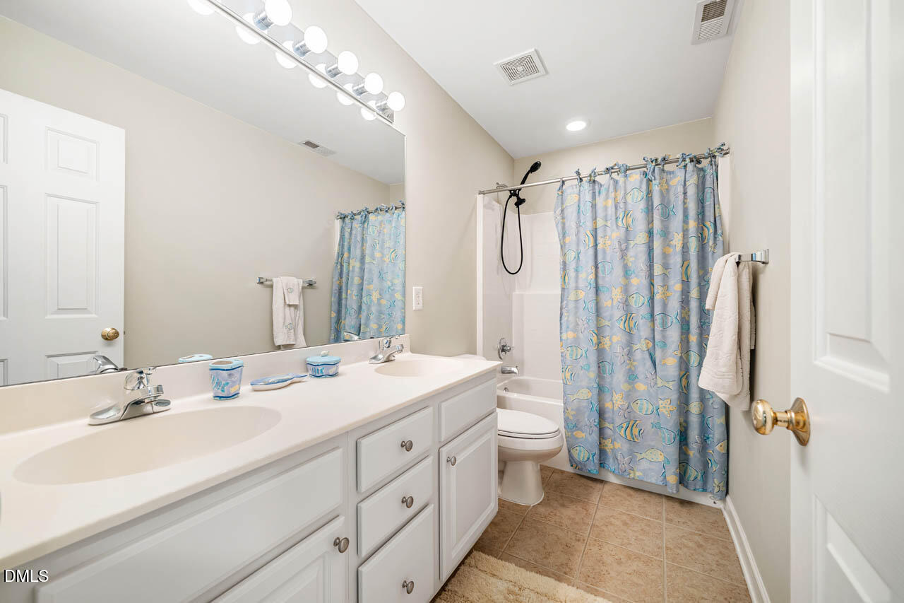 265 Old Chestnut Crossing Moncure, NC 27559 - Photo 29 of 45 a bathroom with double vanity sink and a mirror