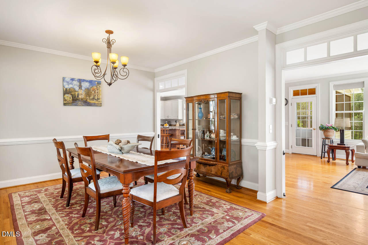 265 Old Chestnut Crossing Moncure, NC 27559 - Photo 5 of 45 a view of a dining room with furniture and wooden floor