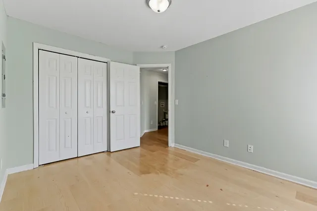 a view of an empty room with closet area