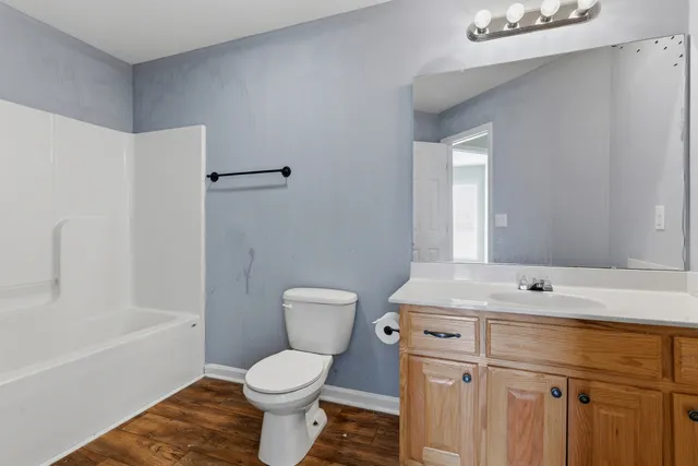a bathroom with a sink toilet vanity and shower