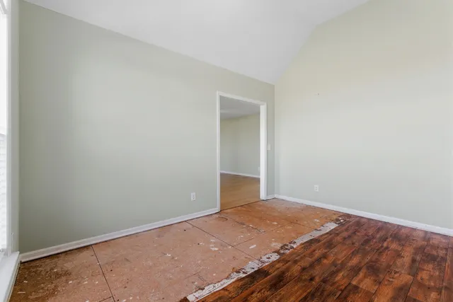 an empty room with wooden floor