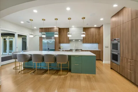 a kitchen with kitchen island stainless steel appliances a sink and counter space