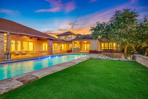 a view of swimming pool from a big yard