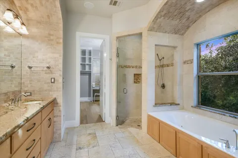 a bathroom with a granite countertop sink toilet and shower