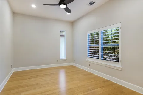 a bathroom with a granite countertop tub sink and mirror