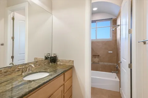 a bathroom with a sink a mirror and a shower