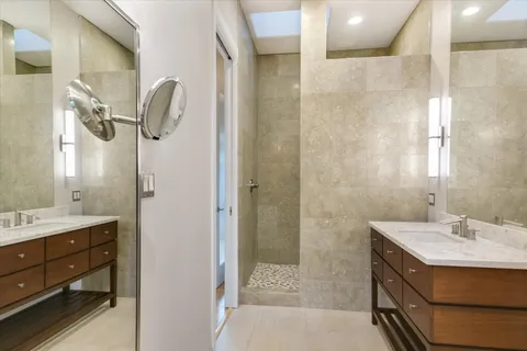 a bathroom with a granite countertop sink a toilet and mirror