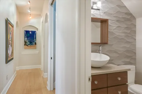 a view of a patio with table and chairs potted plants with wooden floor and fence
