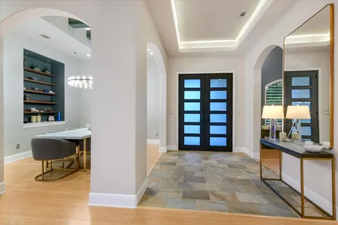 a view of a livingroom with wooden floor and furniture