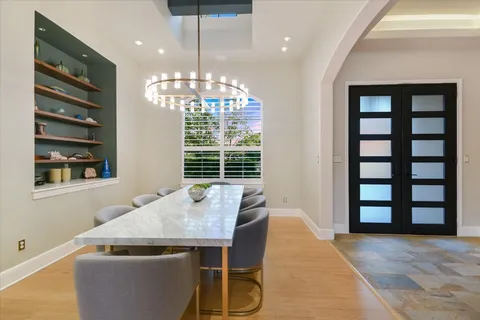 a view of a dining room with furniture and chandelier