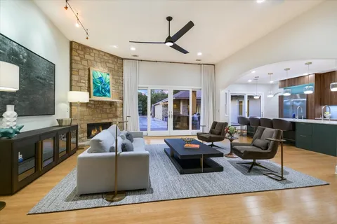a living room with fireplace furniture and a large window
